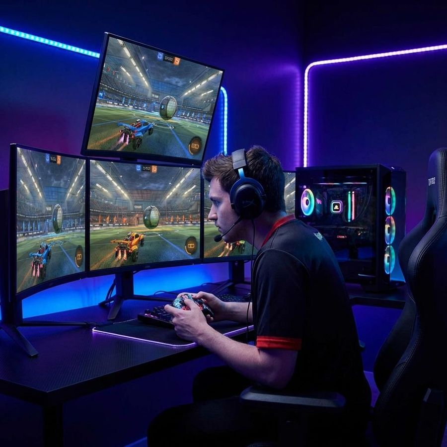 Player reviewing Rocket League gameplay on a multi-monitor setup